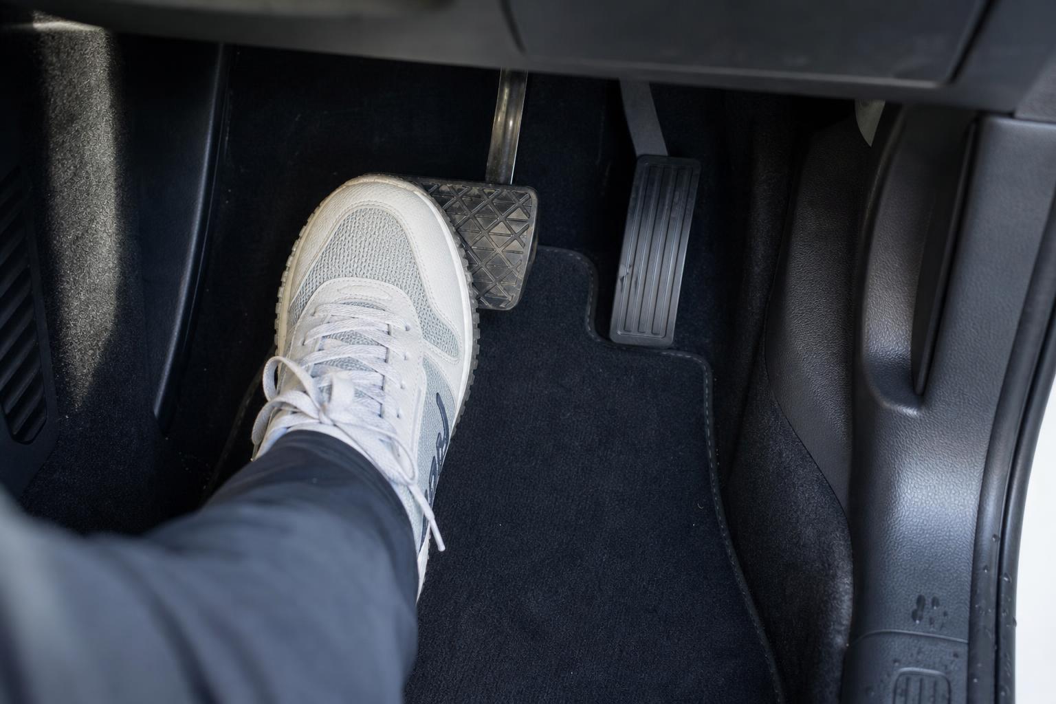 Driver pressing the brake pedal