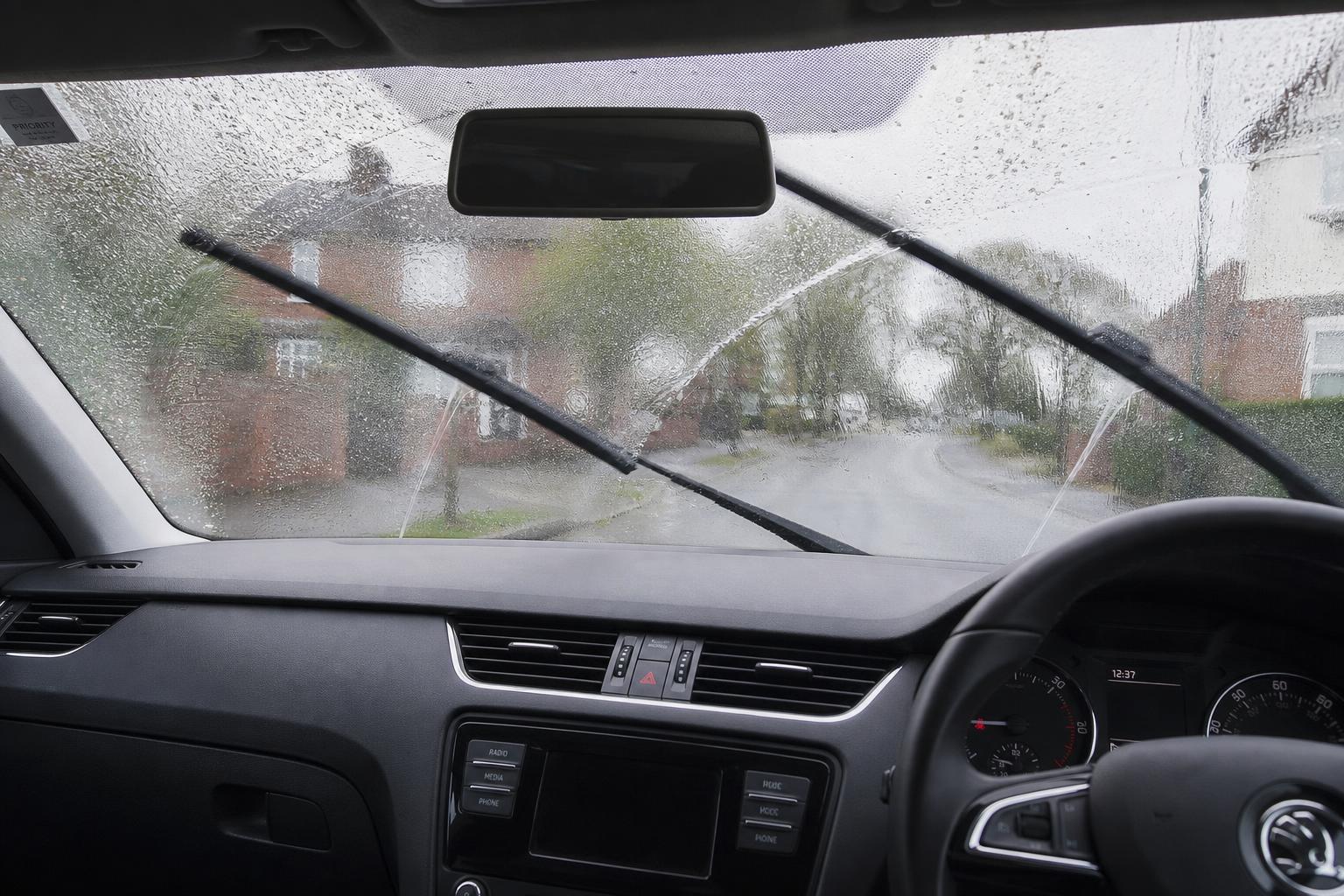 Front windscreen wipers and washer jets in use