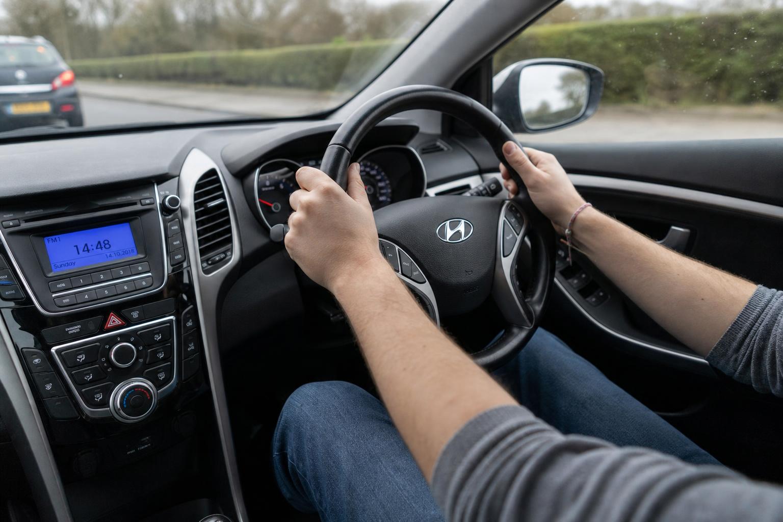 Hands on the car steering wheel